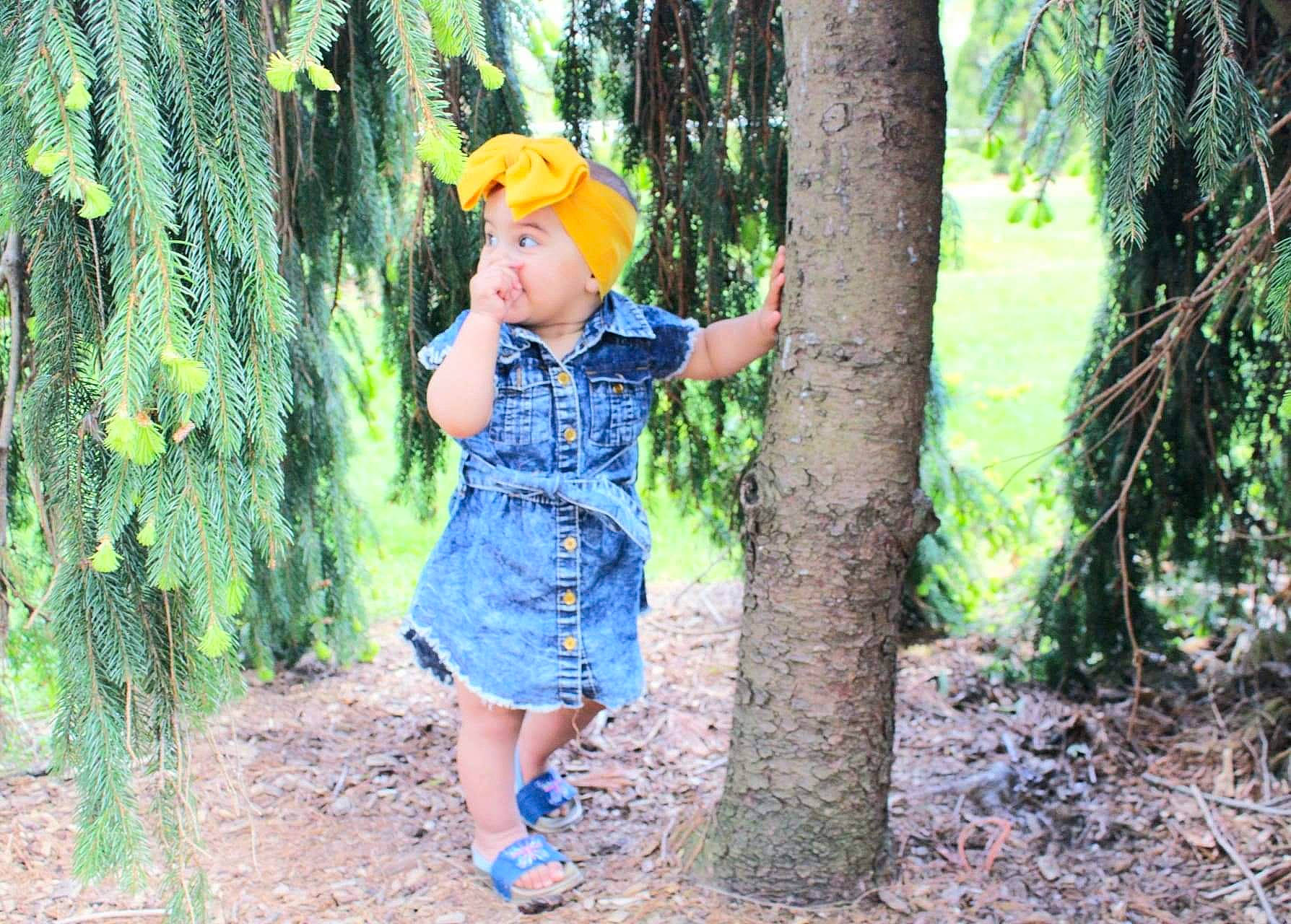 Jazlyn is registered to the contest to win money with this photo: biome, botany, child, denim, electric_blue, forest, fruit, fun, garden, grass, happy, headwear, jungle, leisure, people_in_nature, person, plant, terrestrial_plant, toddler, tree