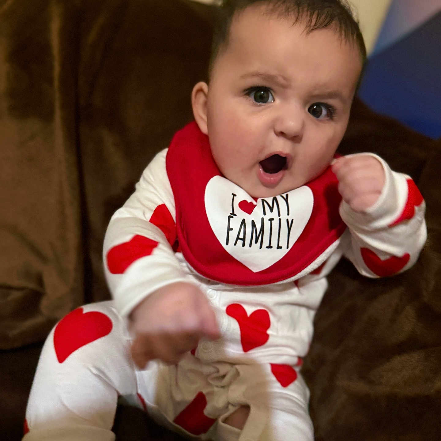 Amelia joined the competition — help win amazing prizes! architecture, baby, bodypart, building, clothing, couch, cushion, face, finger, furniture, hand, head, homedecor, indoors, livingroom, pajamas, person, photography, portrait, sitting