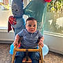 Azari is registered to the contest to win money with this photo: toddler, child, birthday, balloons, high_chair, blue_shirt, jeans, wooden_chair, indoor, party, celebration, number_one, toy_balloon, face, person, casual_clothing, carpet, window, bracelet, sneakers