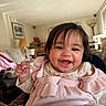 Eliana joined the competition — help win amazing prizes! baby, smiling, indoor, child, cute, portrait, pink_clothing, happy, face, person, infant, cozy, living_room, lamp, sofa, blanket, curtains, home, furniture, toddler