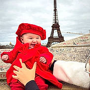 Gabriela participe au concours pour gagner de l'argent avec cette photo : baby, infant, child, red_coat, red_beret, smiling, happy, eiffel_tower, paris, landmark, graffiti, stone_ledge, hands, adult_hand, outdoor, cloudy_sky, portrait, travel, tourist, hat