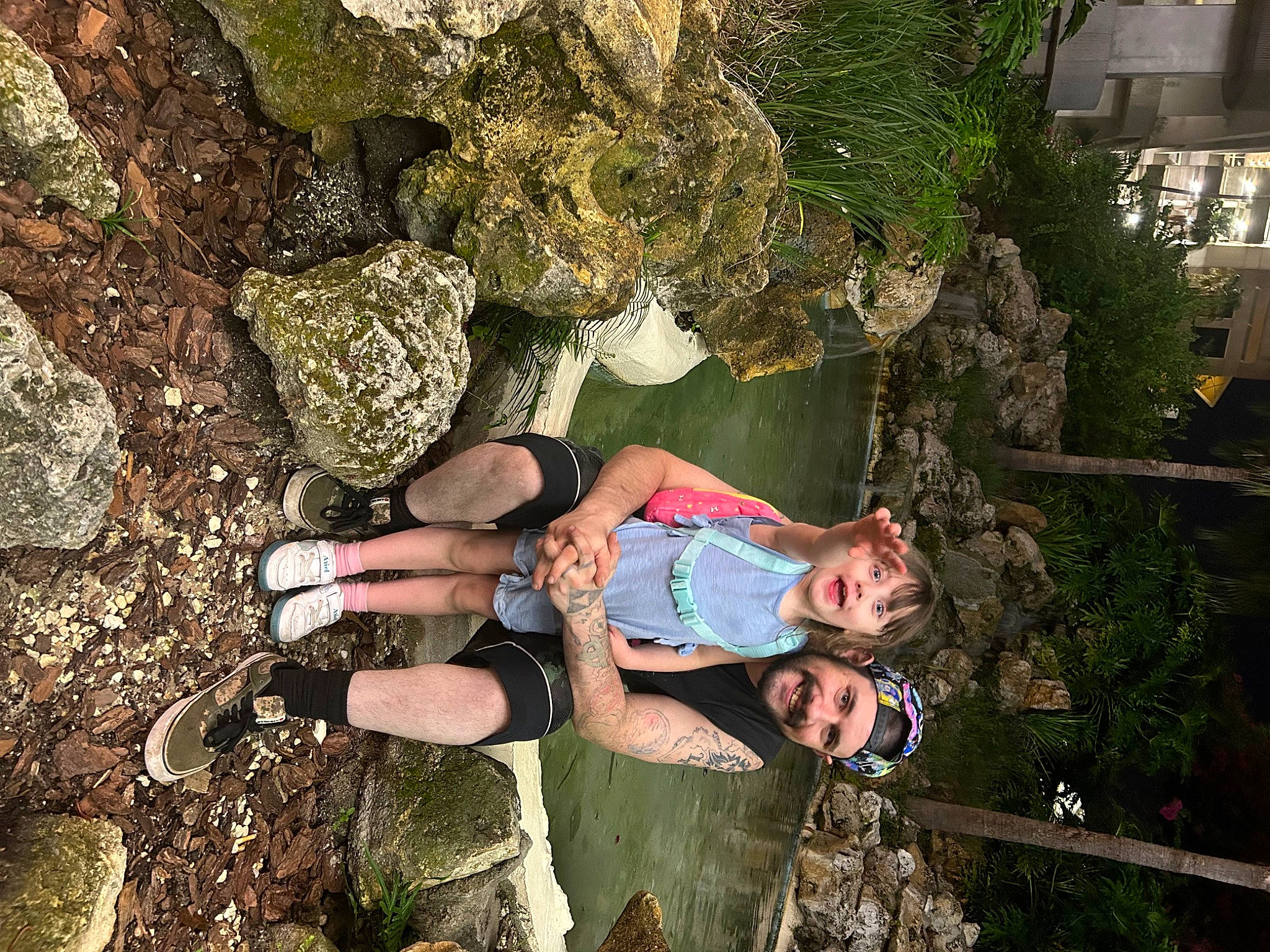 Sapphire is registered to the contest to win money with this photo: adventure, bedrock, boot, fun, grass, headwear, joy, landscape, leg, leisure, people_in_nature, person, plant, recreation, rock, shorts, smile, soil, t_shirt, thigh