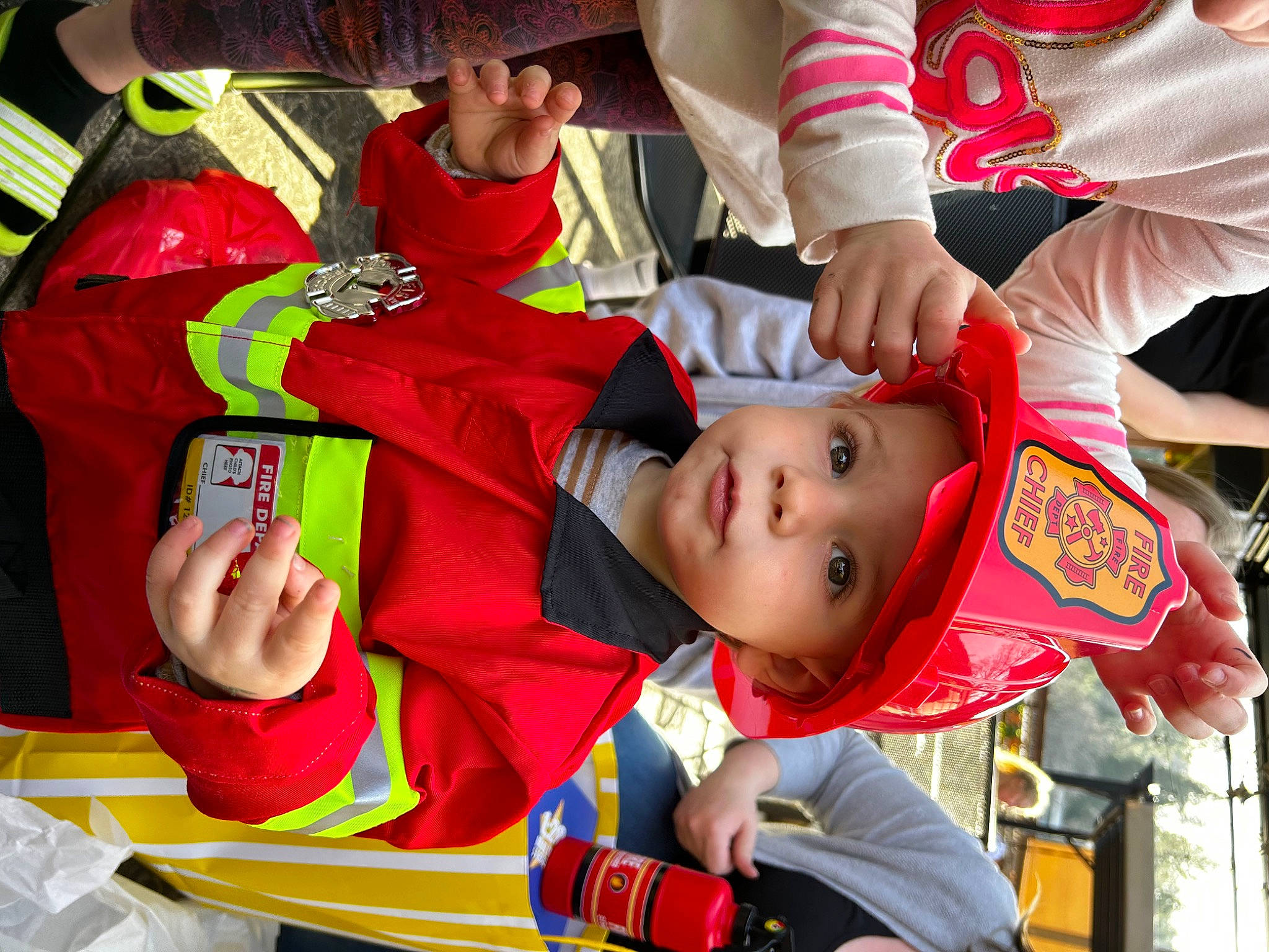 Judah is registered to the contest to win money with this photo: baby, child, costume, event, fan, fictional_character, fun, happy, hat, headwear, leisure, person, product, recreation, room, smile, sun_hat, t_shirt, team, toddler