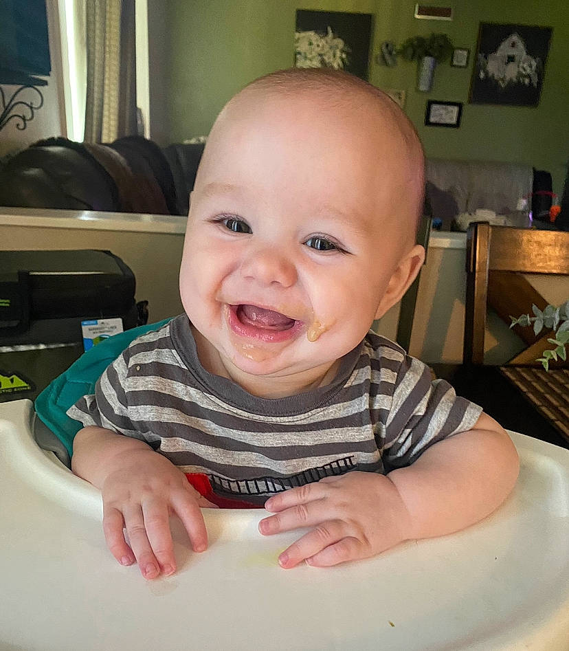 Emmett joined the competition — help win amazing prizes! baby, baby_toddler_clothing, chair, cheek, child, curtain, fun, happy, iris, lip, mouth, nose, person, sitting, skin, sleeve, smile, t_shirt, table, tableware
