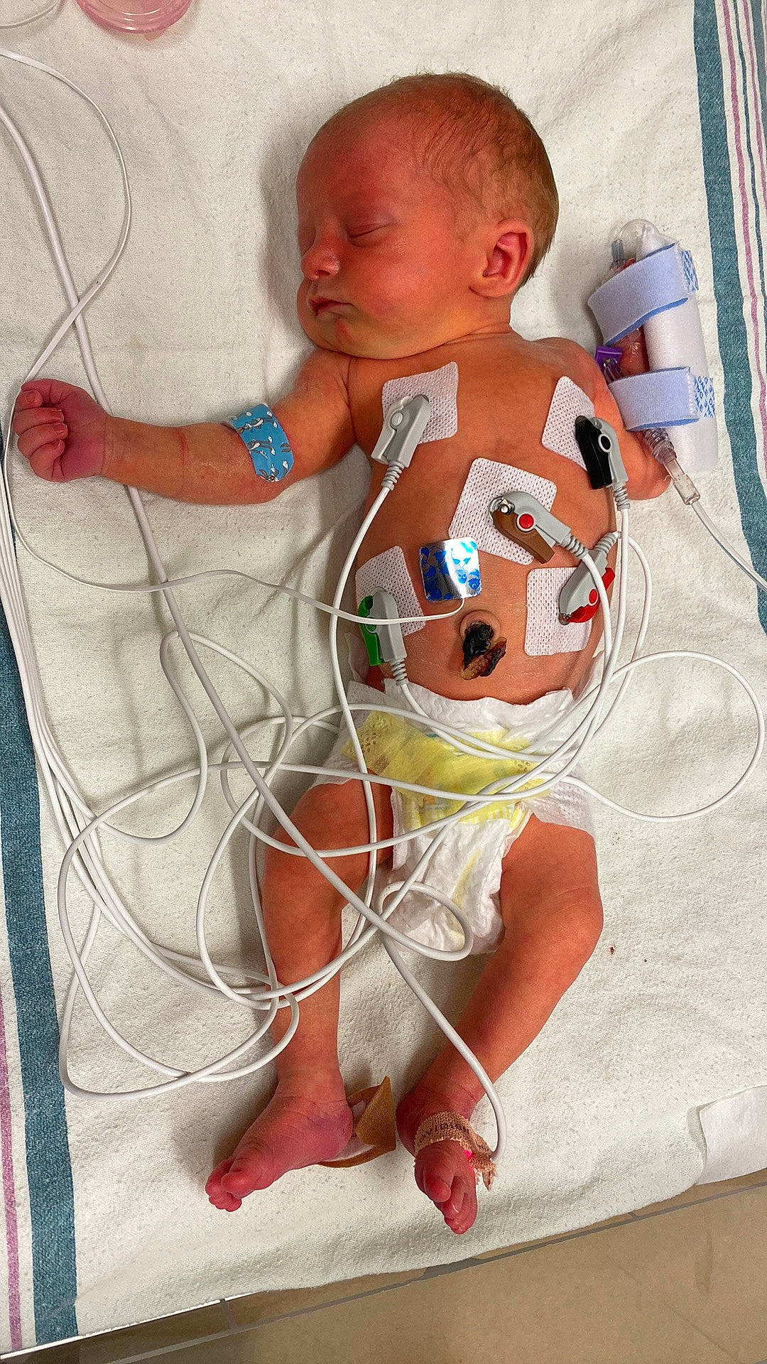 Madilynn is registered to the contest to win money with this photo: baby, baby_products, baby_safety, baby_toddler_clothing, baby_toys, bedding, chest, child, comfort, flooring, happy, linens, pattern, person, play, room, sitting, sleeve, toddler