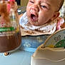 Evealyn joined the competition — help win amazing prizes! baby, bib, bottle, child, chocolate, clothing, cute, expression, face, feeding, food, funny_face, highchair, indoor, infant, messy, mouth_open, person, pink_straw, young