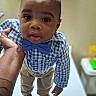 toddler, child, boy, blue_bow_tie, checkered_shirt, khaki_pants, brown_shoes, hand, portrait, indoor, person, cute, fashion, standing, looking_up, skin, short_hair, expression, baby, holding