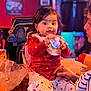 Riddhita joined the competition — help win amazing prizes! child, baby, toddler, woman, face, toy, bib, dress, polka_dot, stroller, bag, table, indoor, restaurant, colorful_lighting, party, hand, sitting, shoe, smile