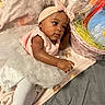 Zynori is registered to the contest to win money with this photo: baby, child, infant, pink, tutu, headband, blanket, soft_toy, gift_basket, cute, lying_down, reaching, adorable, toddler, clothing, earrings, fabric, indoor, person, portrait