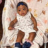 Zynori is registered to the contest to win money with this photo: baby, child, infant, dress, headband, shoes, blanket, chair, floor, wood_floor, animal_pattern, giraffe_pattern, lion_pattern, pink, white, navy_blue, cute, indoors, portrait, sitting