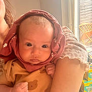 Miia is registered to the contest to win money with this photo: baby, infant, child, person, clothing, hood, arm, indoor, window, furniture, cozy, cute, bear_pattern, skin, face, holding, soft_light, curious, portrait, newborn