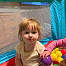 toddler, child, ball_pit, colorful, indoor, play, toys, balls, cute, young_child, mesh_netting, casual_clothing, curly_hair, sitting, hand, purple_ball, yellow_ball, red_ball, blue_ball, green_ball