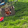 backyard, ball, barefoot, casual, chair, child, daylight, fun, grass, greenery, lawn_chair, messy, orange_clothing, outdoor, plastic_bin, play, relaxed, summer, toddler, toy