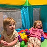 toddler, child, ball_pit, colorful, indoor, play, toy, happy, smiling, girl, plastic_balls, netting, casual_clothing, carpet, furniture, basketball_hoop, fun, playtime, home, family
