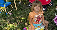 Oaklyn joined the competition — help win amazing prizes! adult, backyard, barefoot, car_toy, casual_clothing, chair, child, grass, moana_tshirt, outdoor, person, plastic_toys, playtime, shade, stroller, summer, sunlight, table, toy_walker, tree