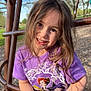 casual_clothing, child, cute, daylight, fun, grass, happy, leisure, nature, outdoor, park, person, play_equipment, playground, portrait, purple_tshirt, smiling, trees, wood_chips, young_girl