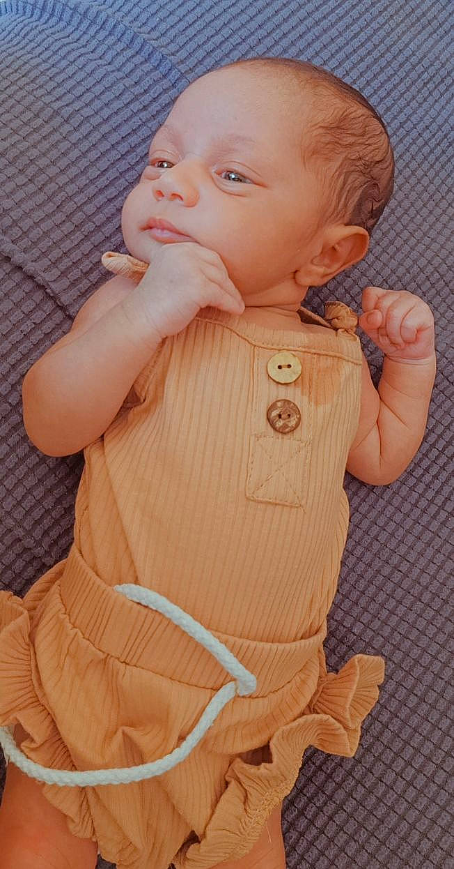 Nouzha participe au concours pour gagner de l'argent avec cette photo : arm, baby, baby_toddler_clothing, cheek, dress, eye, face, finger, gesture, hand, human_body, iris, lip, mouth, nose, outerwear, person, pink, skin, sleeve