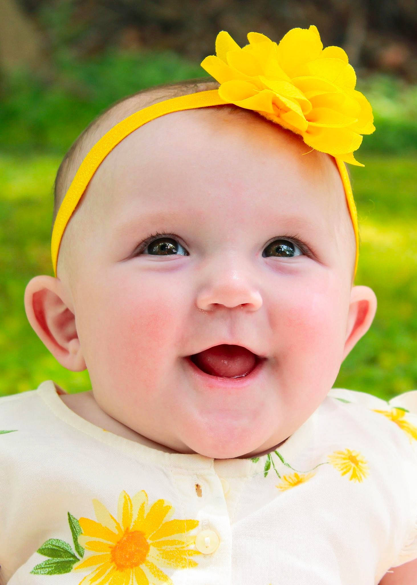 Cheyenne is registered to the contest to win money with this photo: baby, baby_toddler_clothing, cheek, clothing, dress, eye, face, facial_expression, grass, green, happy, head, people_in_nature, person, photograph, pink, skin, smile, toddler, white