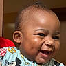 baby, smiling, close_up, indoor, child, mickey_mouse, clothing, happy, portrait, cute, face, infant, person, apparel, young_child, cheerful, expression, colorful, joyful, toddler