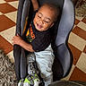 Ashtyn joined the competition — help win amazing prizes! black_shirt, car_seat, casual_clothing, checkered_floor, child, cute, floor_tiles, furniture, grey_pants, happy, indoors, joyful, orthopedic_shoe, person, portrait, rug, seated, smiling, toddler, young_child