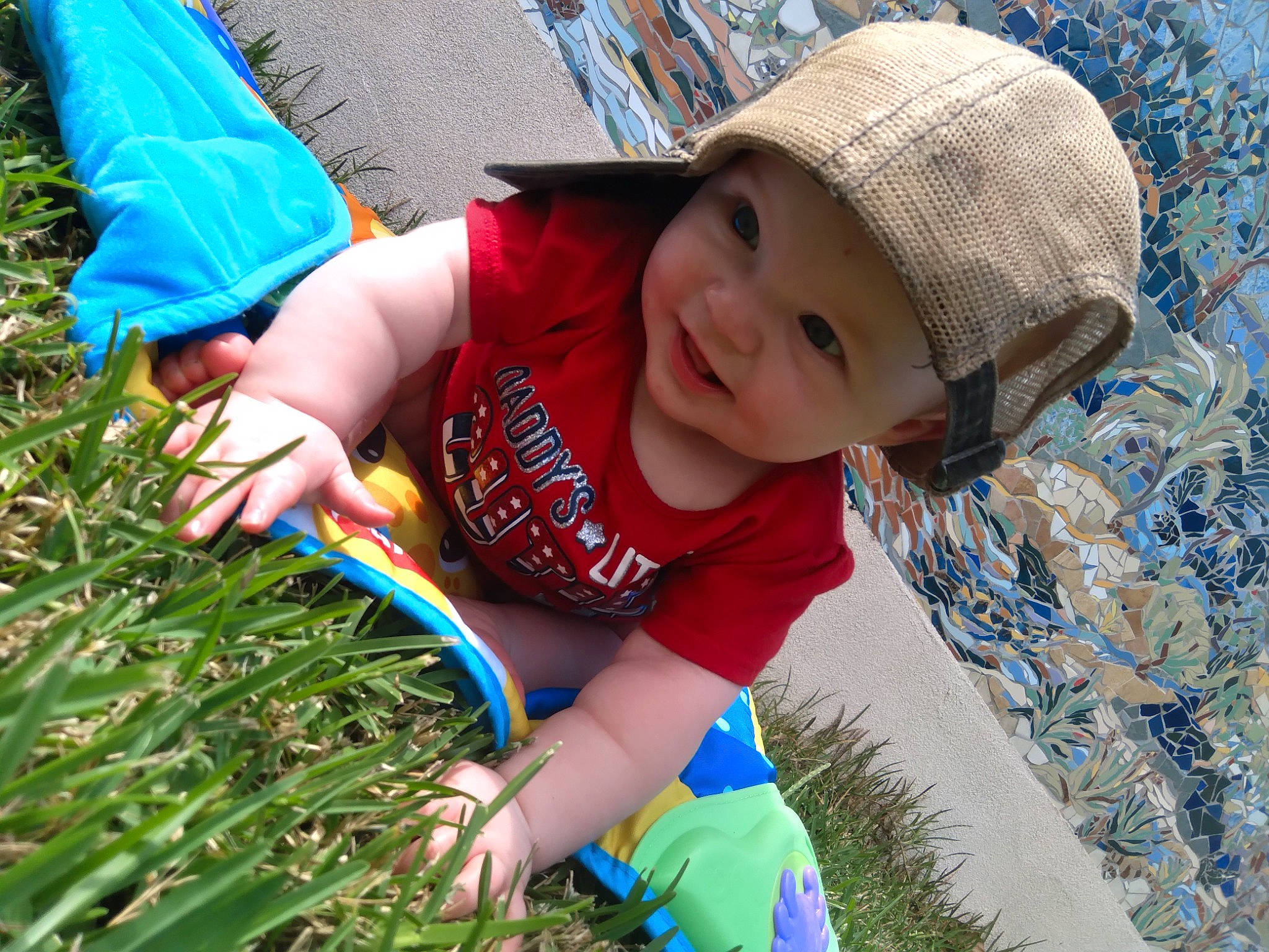 Makinsley joined the competition — help win amazing prizes! baby, baby_toddler_clothing, blue, cap, child, electric_blue, fun, grass, happy, hat, headgear, headwear, leaf, leisure, people_in_nature, person, public_space, recreation, smile, sun_hat