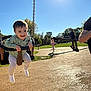 Kelyo a rejoint le concours — aidez-le/la à gagner de superbes lots ! toddler, child, swing, playground, sunlight, outdoor, happy, smiling, park, daytime, blue_sky, clothing, person, fun, leisure, nature, grass, tree, shadow, casual