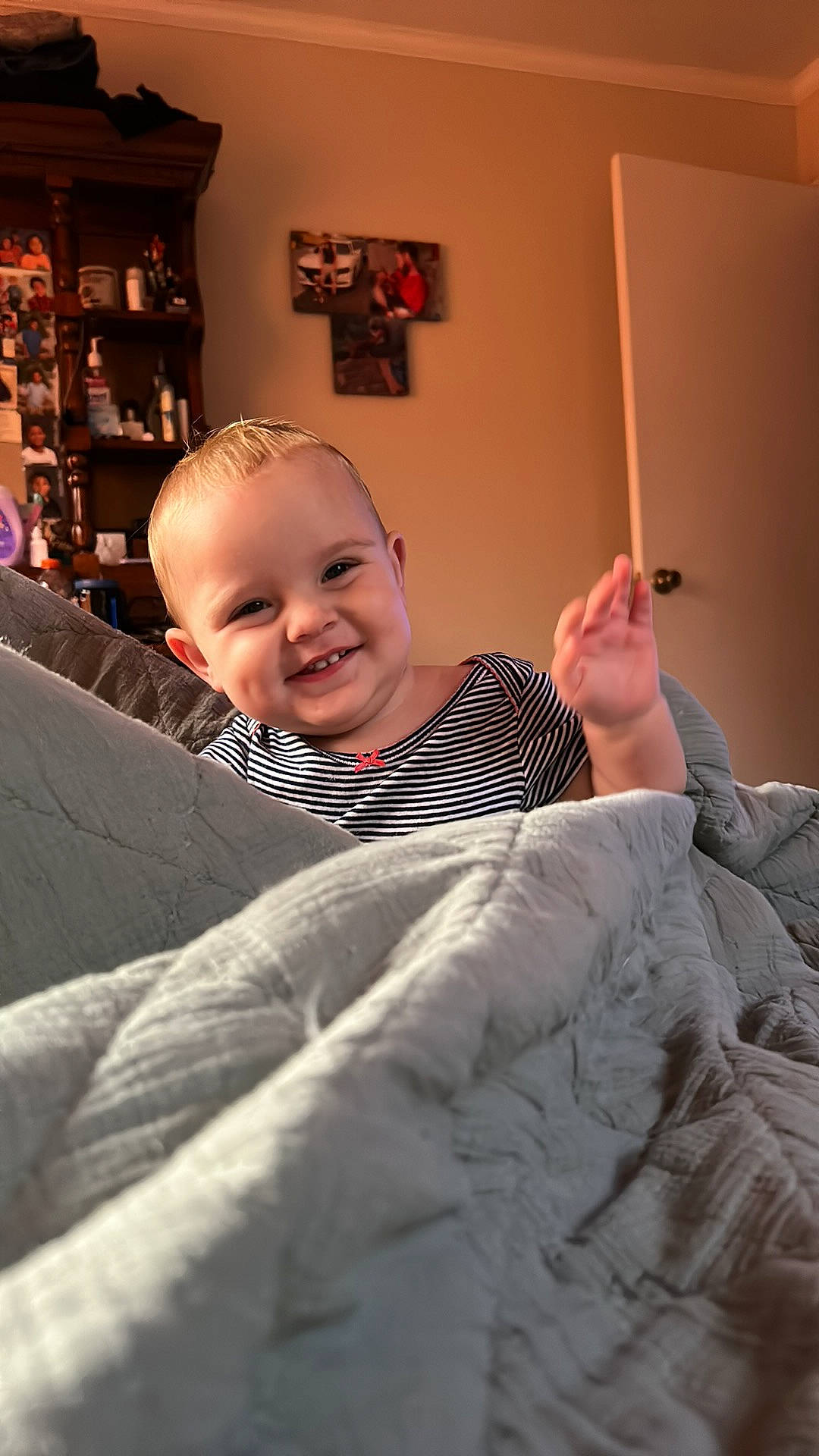 Kinsley joined the competition — help win amazing prizes! baby, bedding, child, comfort, flash_photography, flooring, fun, fur, hairstyle, happy, joy, laugh, linens, person, picture_frame, room, shelf, sitting, smile, t_shirt