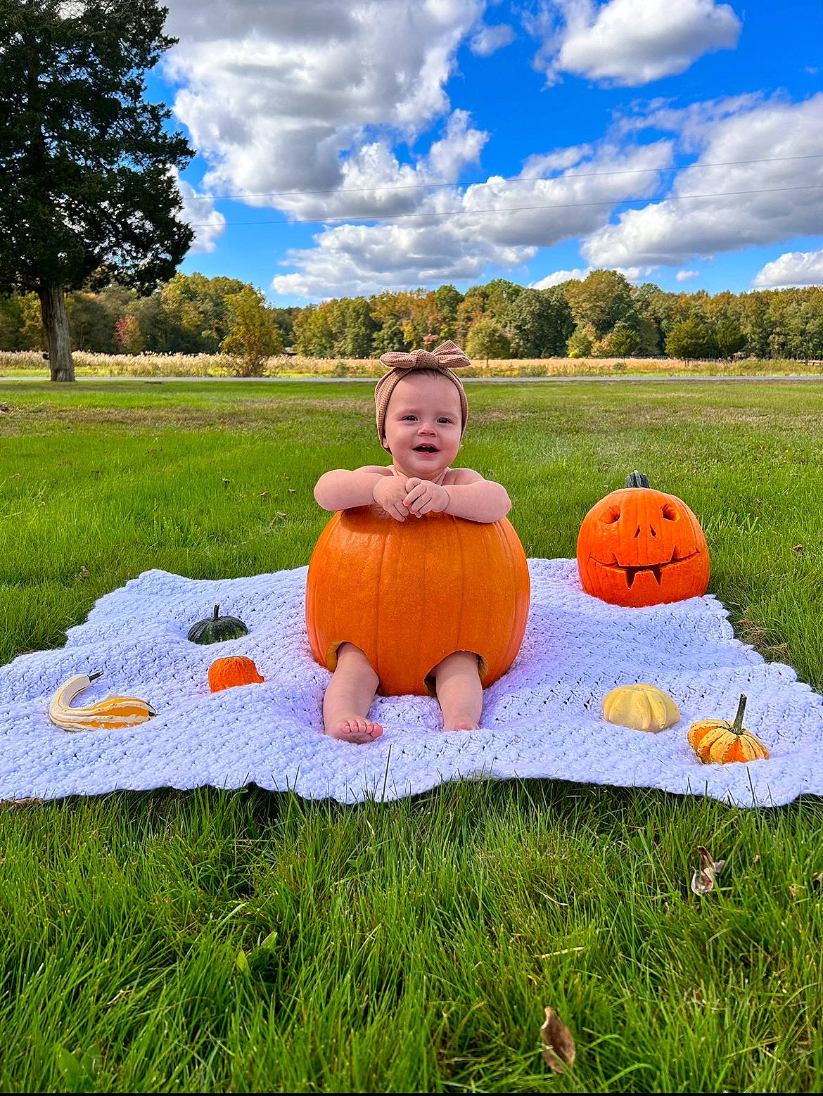 Kinsley joined the competition — help win amazing prizes! baby_toddler_clothing, calabaza, cloud, cucurbita, facial_expression, fun, grass, grass_family, grassland, happy, joy, landscape, leisure, meadow, people_in_nature, person, plant, pumpkin, sky, smile