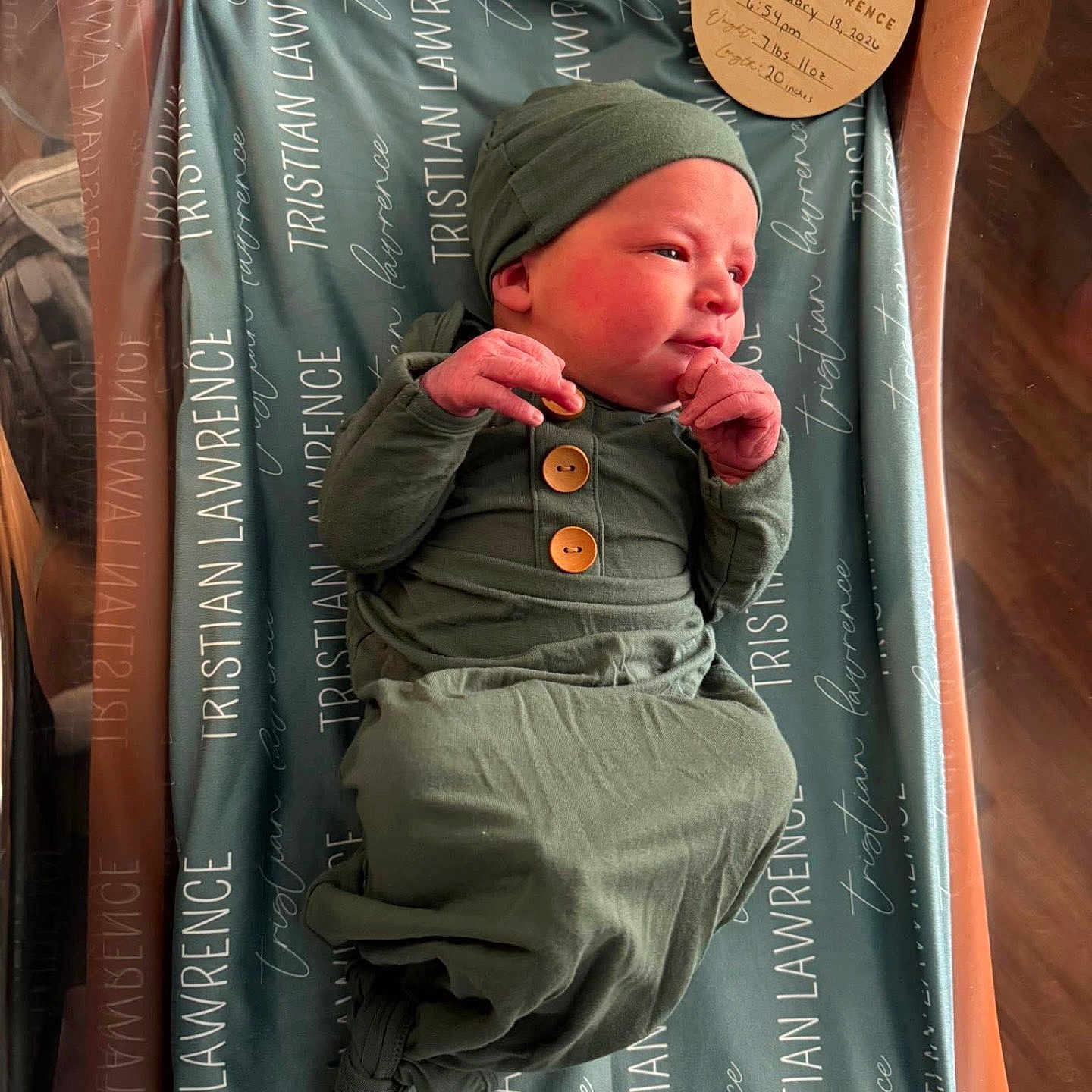 Tristian joined the competition — help win amazing prizes! baby, blanket, cheeks, closeup, crib, green_clothing, hands, hospital_bassinet, hospital_room, infant, knit_hat, maternity, name_tag, newborn, newborn_card, portrait, sleepy, swaddle, wooden_buttons, wrapped