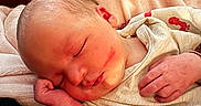 Tristian is registered to the contest to win money with this photo: baby, bed, blanket, cheek, cozy, ear, fabric, face, hair, hand, headboard, infant, lips, newborn, peaceful, pillow, portrait, skin, sleeping, swaddle