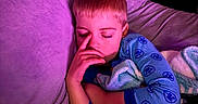 Sawyer joined the competition — help win amazing prizes! child, sleeping, pajamas, blanket, couch, indoor, cozy, purple_light, relaxation, comfort, young, peaceful, resting, soft_texture, home, portrait, person, bedtime, calm, toddler