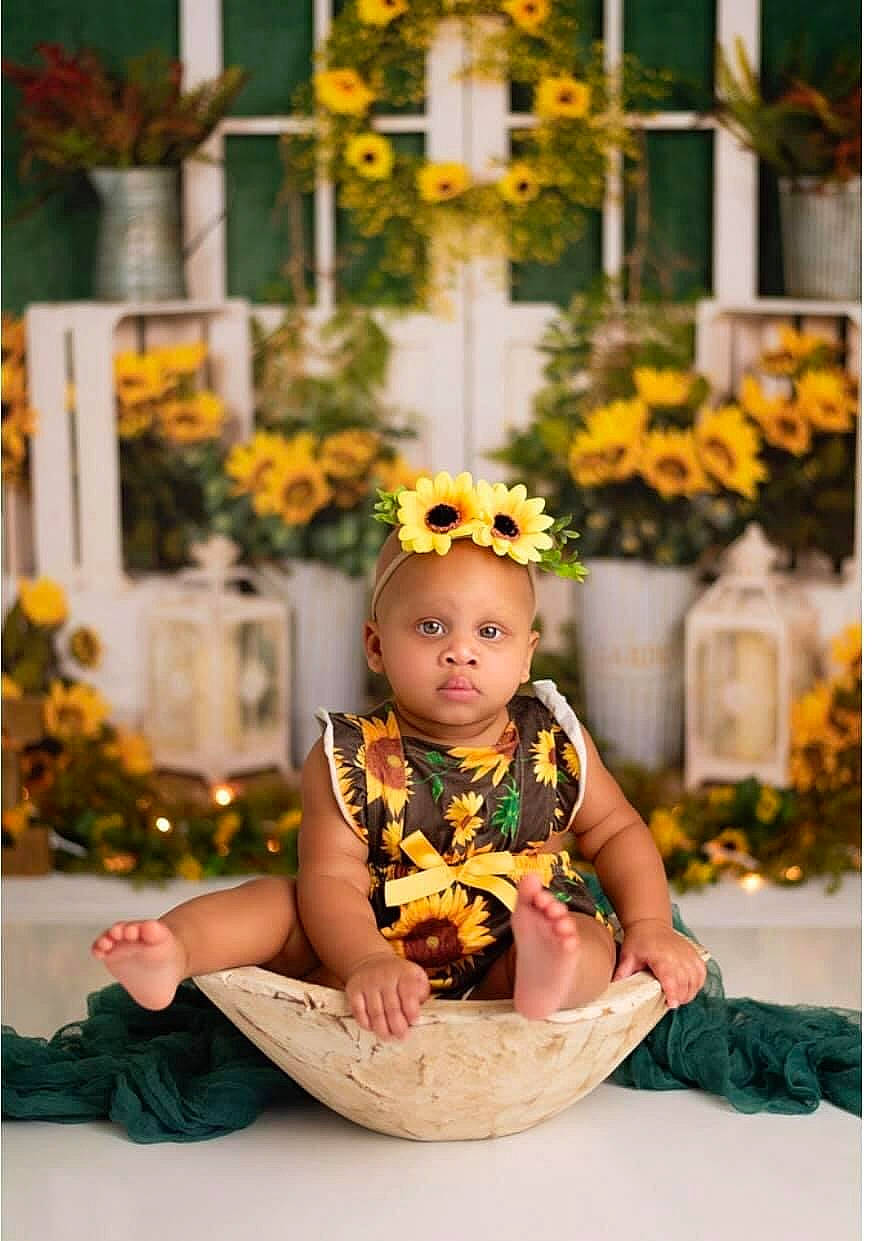 Liberty is registered to the contest to win money with this photo: baby, cross, dress, event, floral_design, flower, flower_arranging, fun, happy, jewellery, leisure, orange, peach, person, plant, portrait_photography, sitting, symbol, toddler, tradition