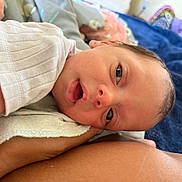 Chelsea joined the competition — help win amazing prizes! arm, baby, bed, blanket, closeup, clothing, cute, face, indoor, infant, newborn, person, portrait, resting, skin, sleepy, soft, tender, white_shirt, young_child