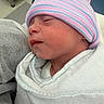 Chelsea is registered to the contest to win money with this photo: baby, blanket, child, closeup, cozy, cute, face, hat, headwear, hospital, infant, newborn, peaceful, portrait, resting, skin, sleeping, soft, striped_hat, swaddle