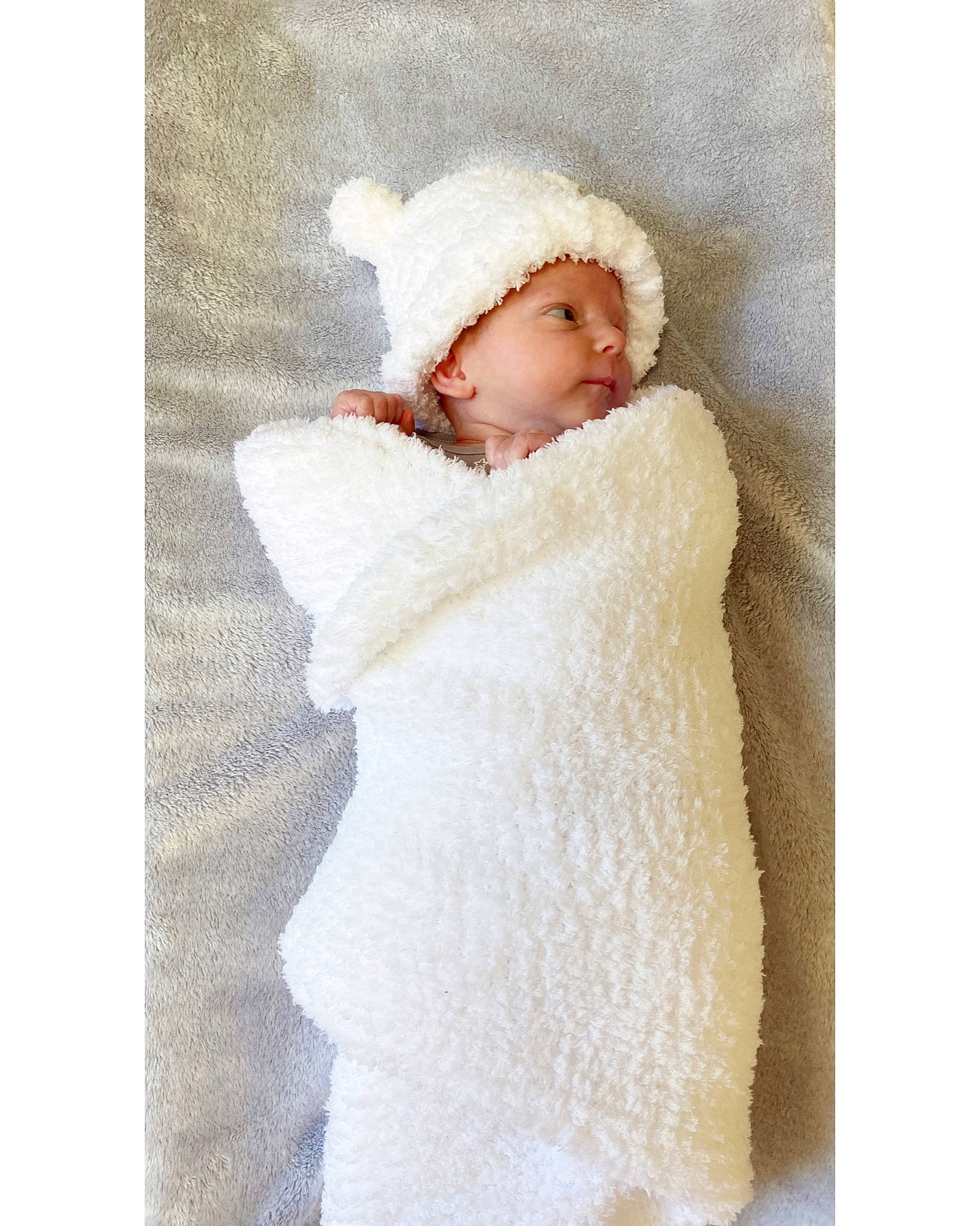 Oliver is registered to the contest to win money with this photo: baby, beige, bonnet, child, fur, fur_clothing, headgear, headwear, hood, outerwear, person, robe, textile, toddler, white, winter, wool