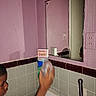 Dewayne joined the competition — help win amazing prizes! child, face, bathroom, sink, mirror, faucet, cleaning_product, bottle, hand, motion_blur, pink_wall, tiles, portrait, indoors, home, plumbing, reflection, short_hair, standing, household