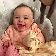 Ezra joined the competition — help win amazing prizes! baby, baby_boy, baby_girl, blanket, child, closeup, cozy, cuddly, cute, face, hand, happy, indoors, infant, pink_sweater, portrait, smiling, soft_toy, stuffed_animal, warm