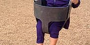 Azlan joined the competition — help win amazing prizes! toddler, child, swing, playground, outdoor, trees, woodchips, baby_swing, person, clothing, park, play_equipment, daytime, curious, holding, barefoot, seat, chain, expression, casual