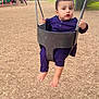 toddler, child, swing, playground, outdoor, trees, woodchips, baby_swing, person, clothing, park, play_equipment, daytime, curious, holding, barefoot, seat, chain, expression, casual