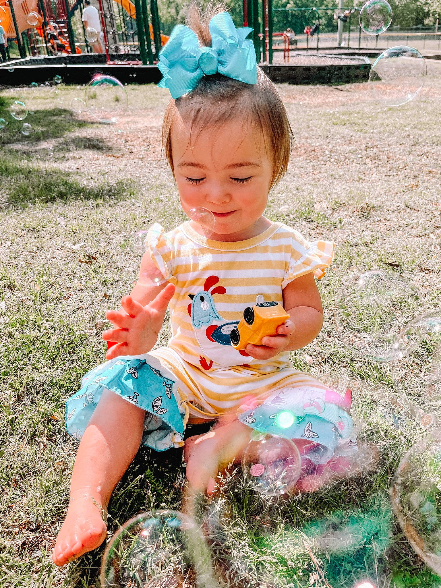 Kingsley joined the competition — help win amazing prizes! baby_toddler_clothing, child, dress, eye, fun, grass, green, happy, hat, head, leisure, people_in_nature, person, pink, plant, recreation, sitting, smile, spring, summer