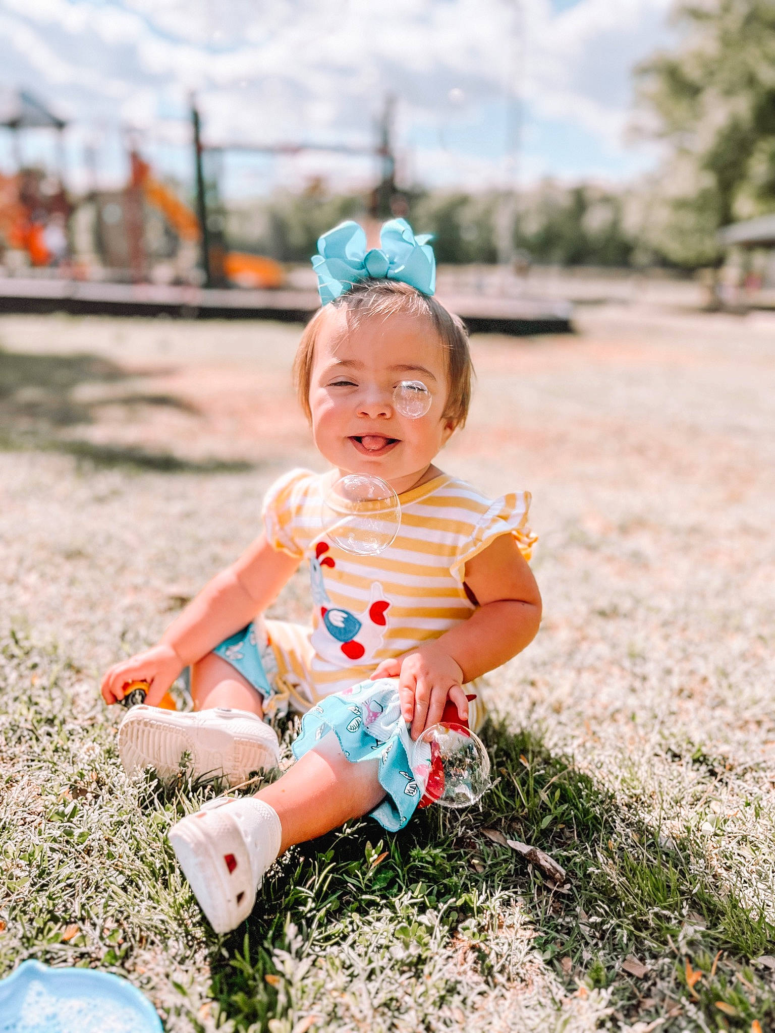 Kingsley is registered to the contest to win money with this photo: baby, baby_toddler_clothing, child, eye, fashion_accessory, fun, grass, happy, hat, leisure, people_in_nature, person, plant, recreation, sitting, sky, smile, summer, sunlight, toddler