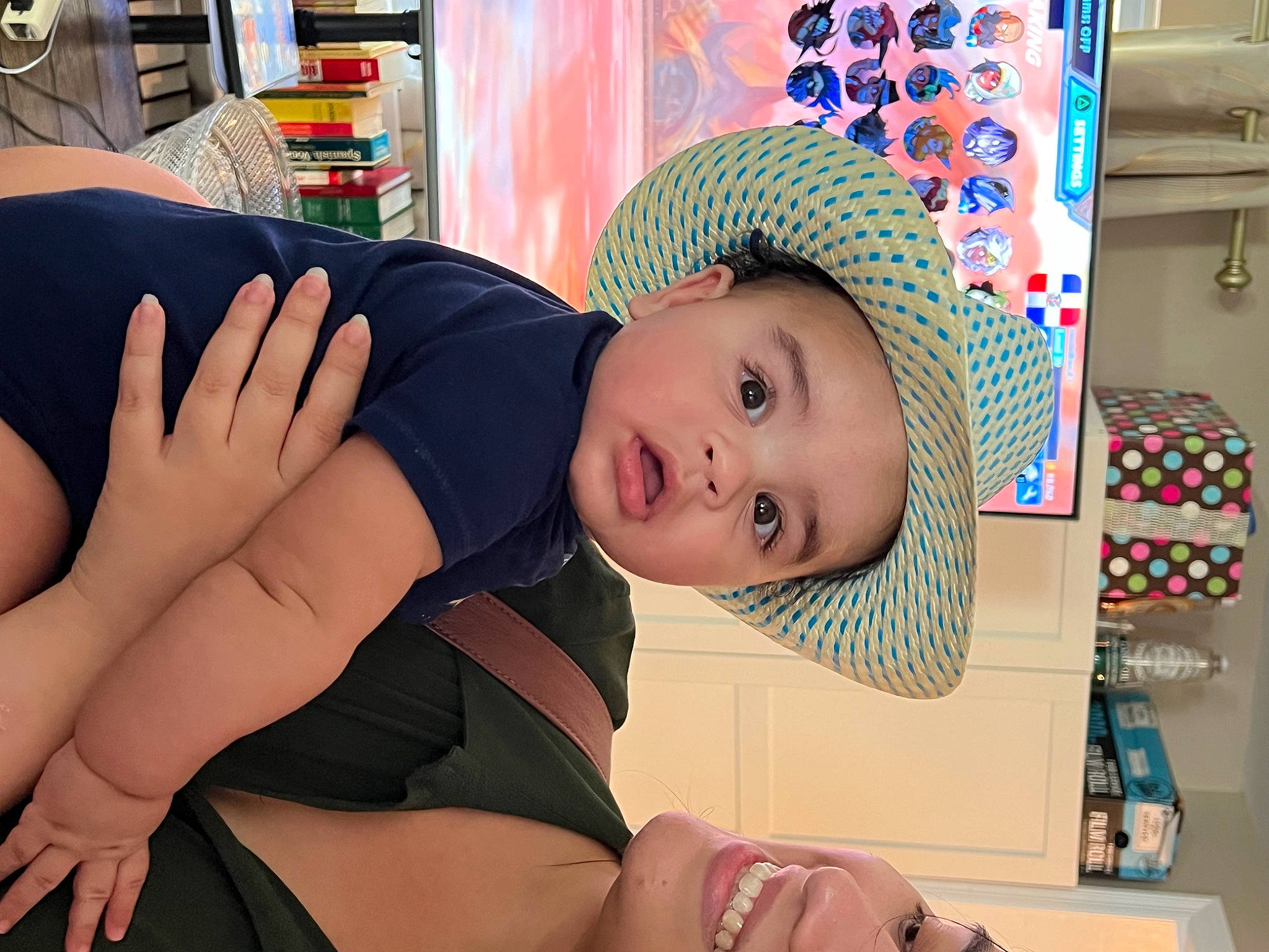 Isaiah is registered to the contest to win money with this photo: abdomen, baby, cap, chest, child, elbow, fashion_accessory, fun, hat, headwear, human_leg, knee, party_supply, pattern, person, room, sportswear, sun_hat, surprise, thigh