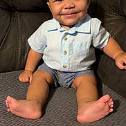 Lataivean joined the competition — help win amazing prizes! baby, child, smiling, sitting, couch, blue_shirt, shorts, barefoot, indoor, happy, infant, cute, portrait, furniture, home, young_child, skin, face, person, seated