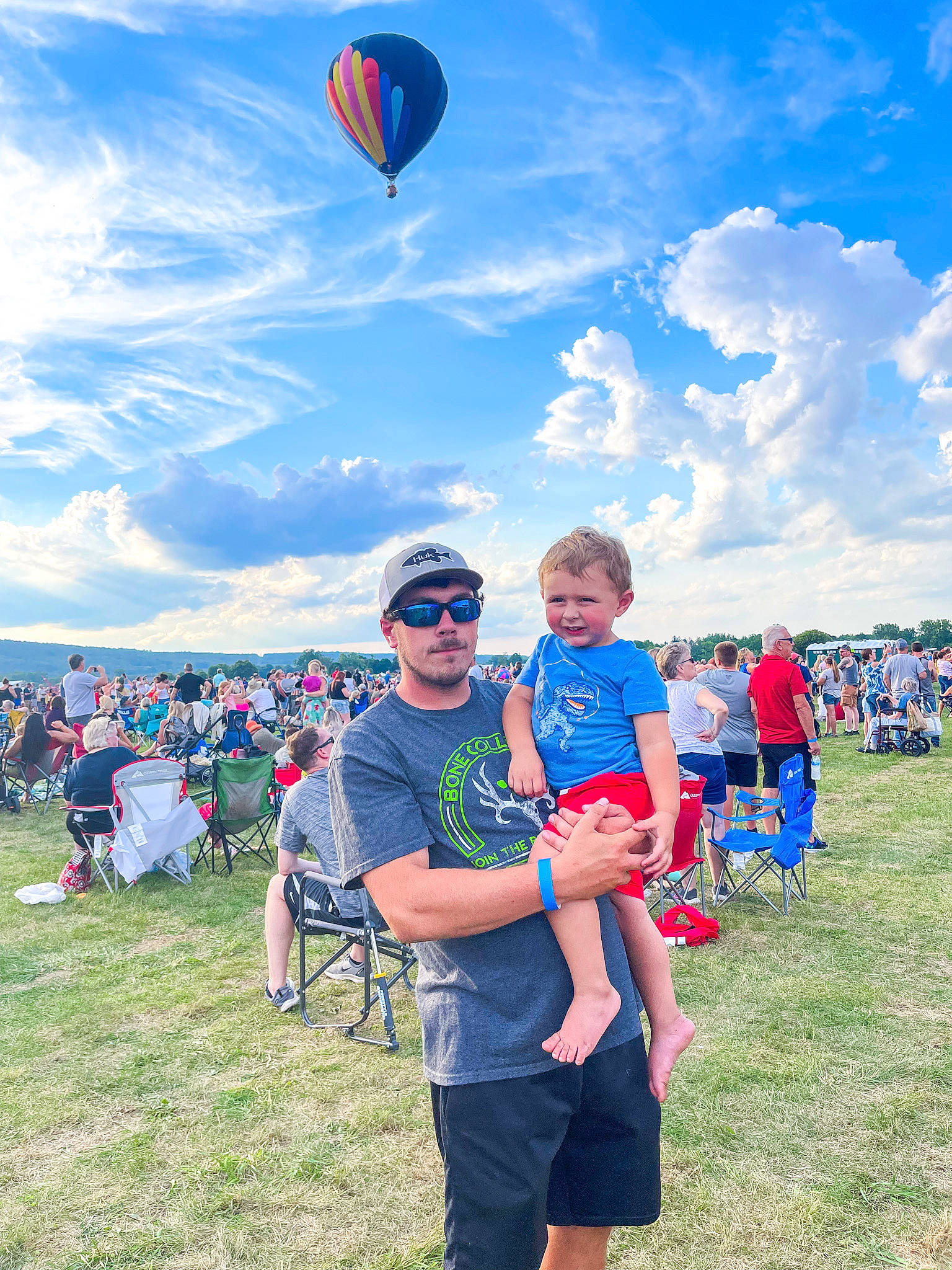 Landyn joined the competition — help win amazing prizes! aerostat, balloon, blue, cloud, fun, grass, grassland, happy, headwear, hot_air_balloon, hot_air_ballooning, leisure, outdoor_recreation, person, recreation, shorts, sky, smile, summer, t_shirt