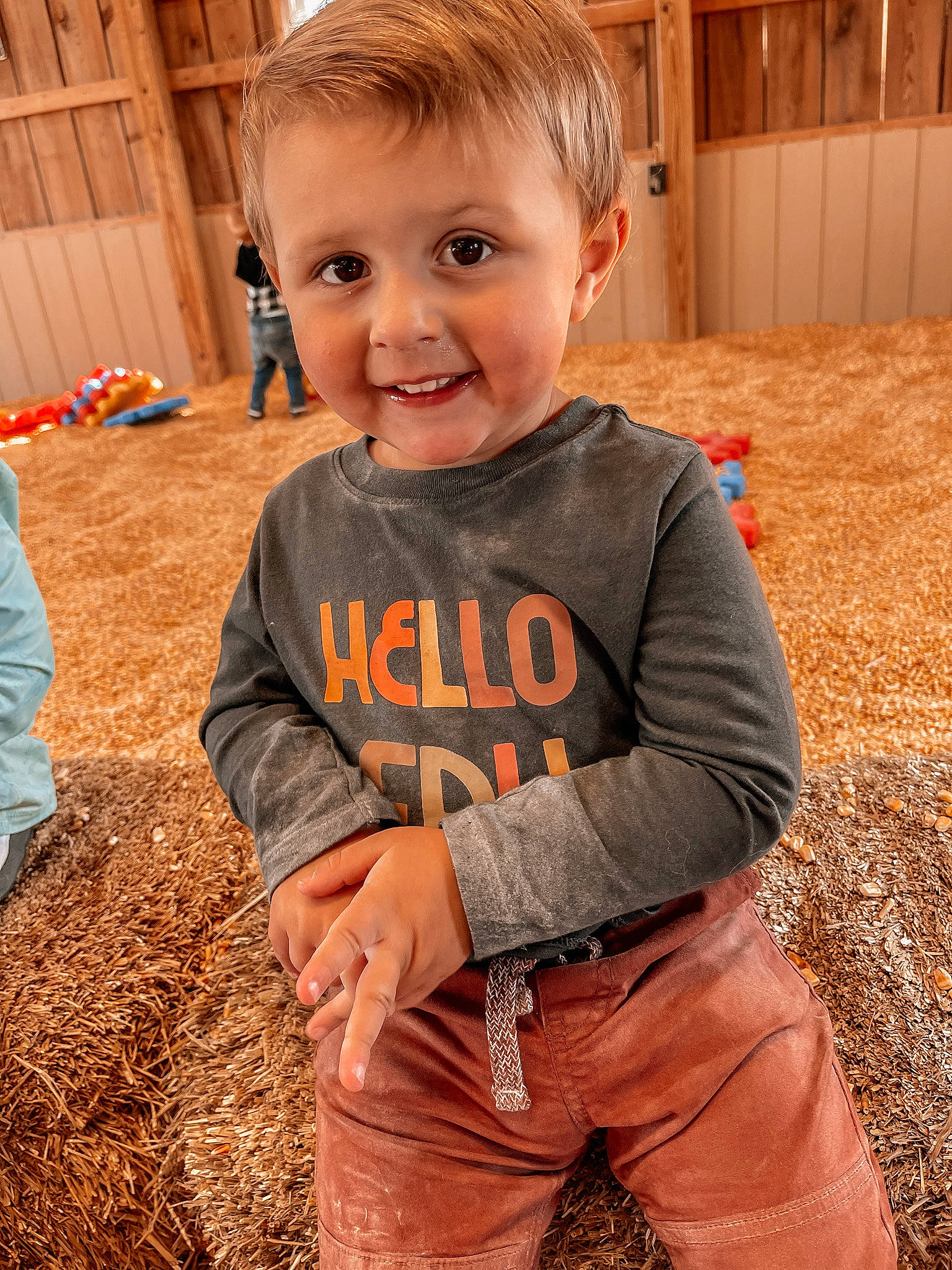 Landyn is registered to the contest to win money with this photo: baby, child, flooring, fun, grass, hair, hairstyle, happy, head, joy, orange, people_in_nature, person, plant, pumpkin, sitting, sleeve, smile, t_shirt, toddler
