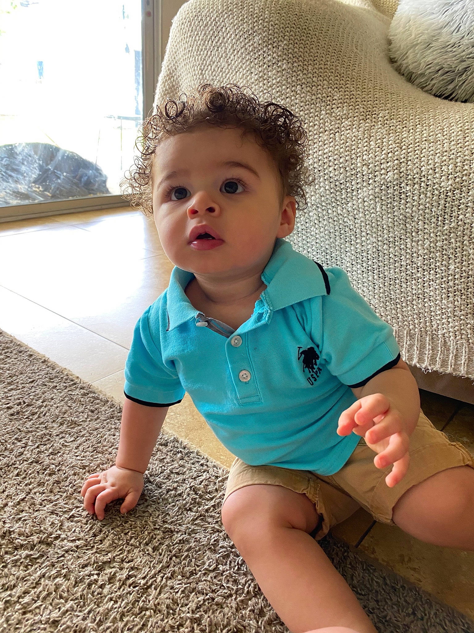 Daylen is registered to the contest to win money with this photo: baby, baby_toddler_clothing, cheek, child, face, floor, flooring, head, leg, person, play, sitting, skin, toddler, turquoise, vacation