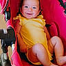 Raelynn is registered to the contest to win money with this photo: baby, baby_boy, baby_face, baby_feet, baby_girl, baby_legs, child, comfort, cute, happy, indoors, infant, person, portrait, red_stroller, seat, smiling, stroller, yellow_clothing, young_child