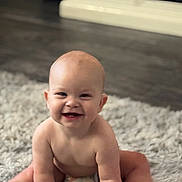 Stetson is registered to the contest to win money with this photo: baby, smiling, infant, sitting, cute, happy, child, indoor, soft_rug, naked_torso, diaper, floor, portrait, young, crawling, skin, head, hands, legs, expression