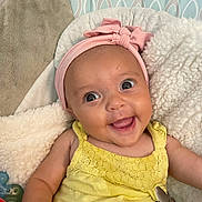 London is registered to the contest to win money with this photo: baby, bed, bonnet, cap, clothing, couch, cushion, face, furniture, happy, hat, head, homedecor, laughing, newborn, person, photography, portrait, quilt, smile