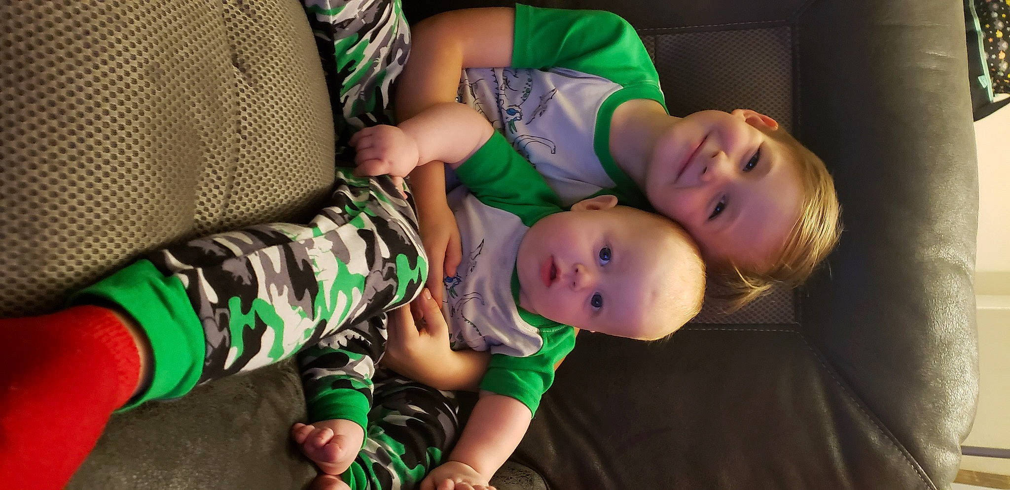 Dillinger is registered to the contest to win money with this photo: baby, baby_toddler_clothing, child, comfort, event, flash_photography, fun, grass, green, happy, hat, joy, leisure, mammal, pattern, person, sitting, smile, sock, t_shirt